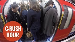 Commuters packed together on the London underground [upl. by Alamak]